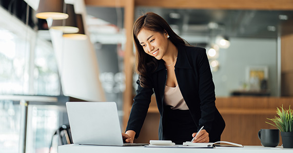 woman issuing recognition to another employee on laptop